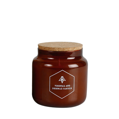 Vela de cera de abeja en vaso de cristal grande.